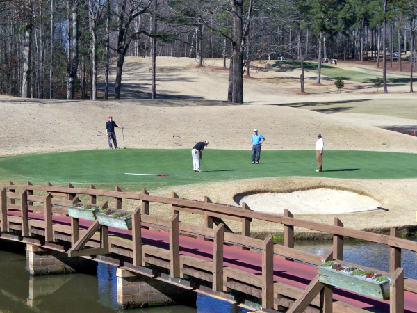 Four men playing golf